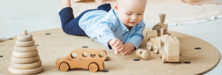 Baby spielt mit Holzspielzeug